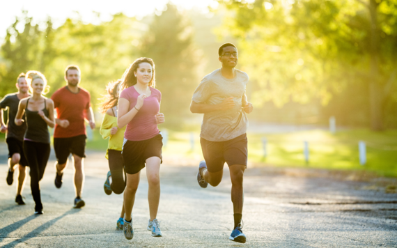 A group of men and women running in countryside
