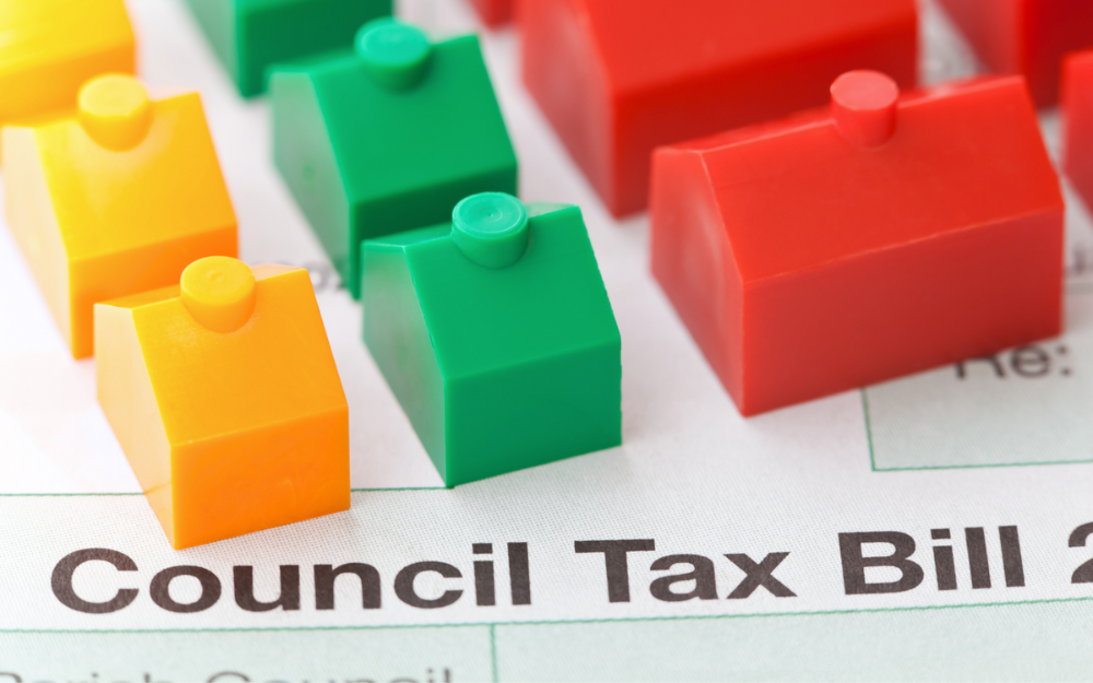 A Council Tax bill with small plastic houses placed on it