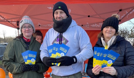 Three members of Wokingham Borough Council's Ukraine team in winter clothing. holding information leaflets