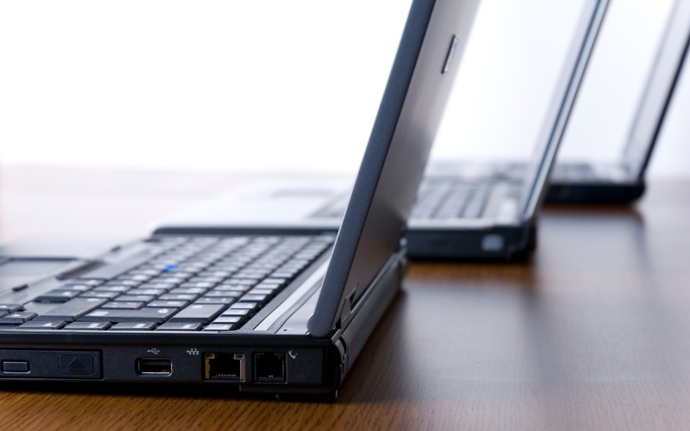Three laptops on a desk