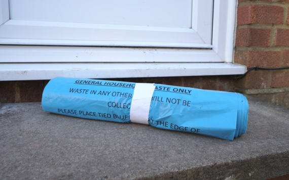 Photo shows roll of blue general rubbish bags
