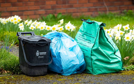 A food waste bin, two recycling bag and a general rubbish bag at the kerbside