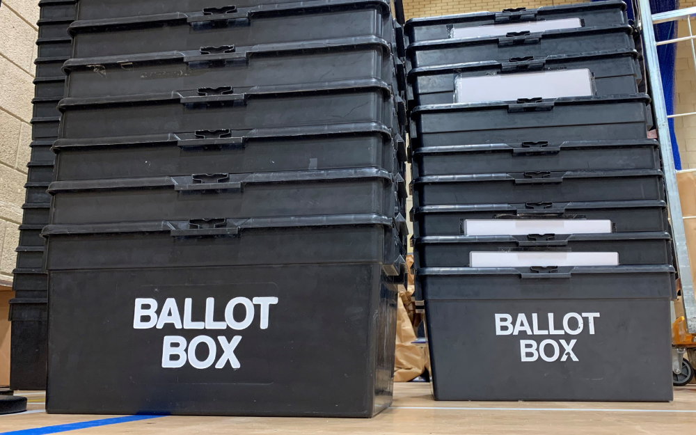 Stacks of empty ballot boxes on the floor