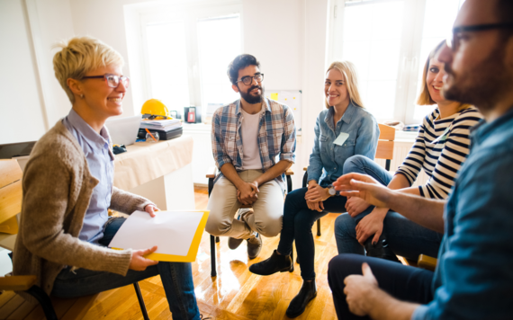 A group of people are sat together 