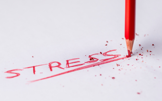 The word stress is written in red pen across a page
