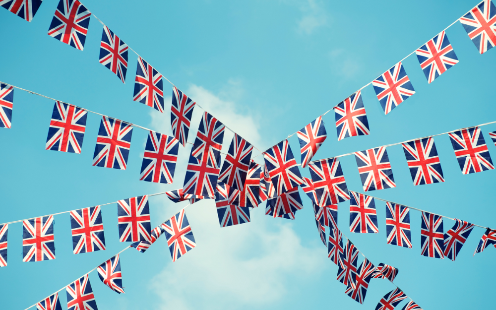 Union flag bunting across a blue sky