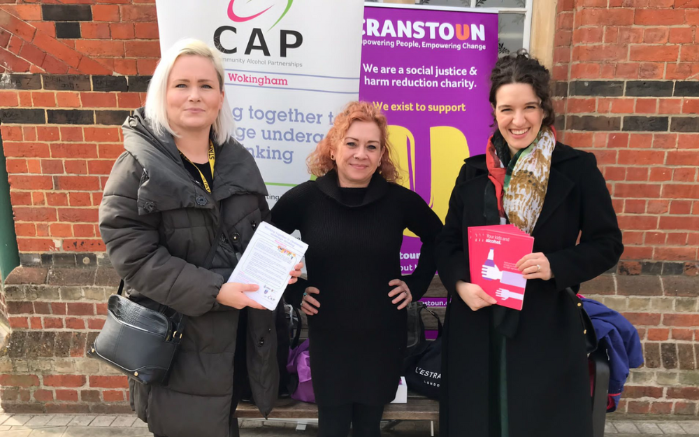 Three women who work for Wokingham Community Alcohol Partnership stand with promotional materials in Wokingham town centre