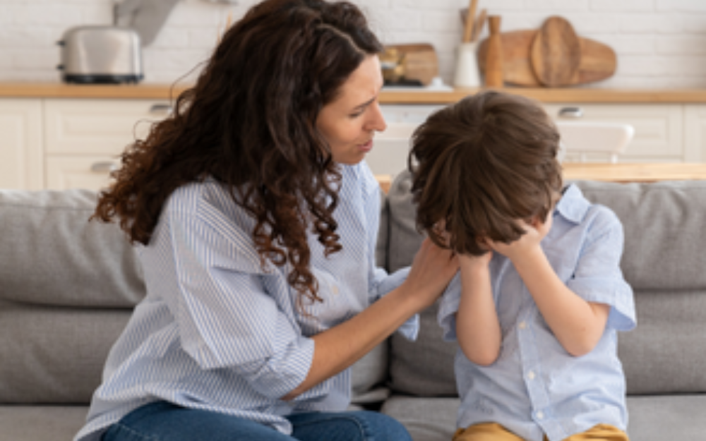 A woman comforts an upset child 