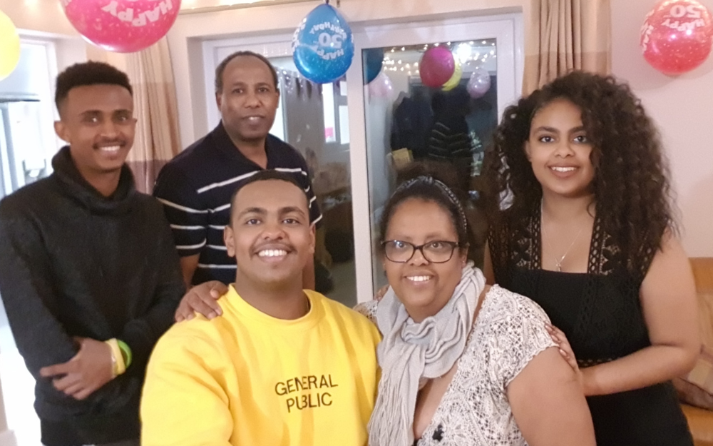 Freweyni, one of our foster carers, and her family smile at the camera