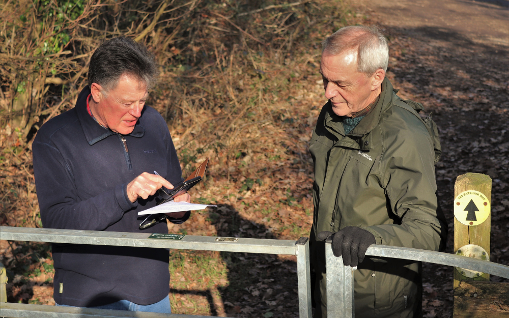 Two men on a walking route in Wokingham Borough, using a new walking route map tool on their mobile devices