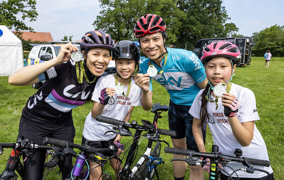 Family of cyclists with their medals