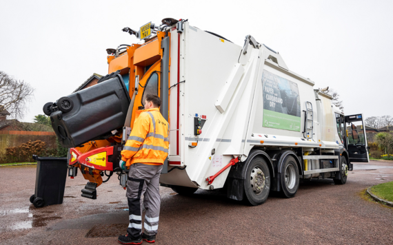 Waste colllection crew loading a wheeled bin to a waste vehicle