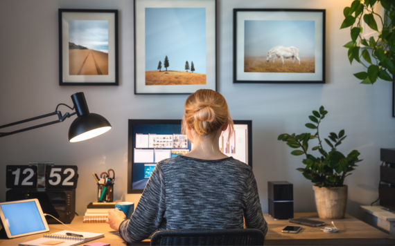 Person sat at a computer at home working 