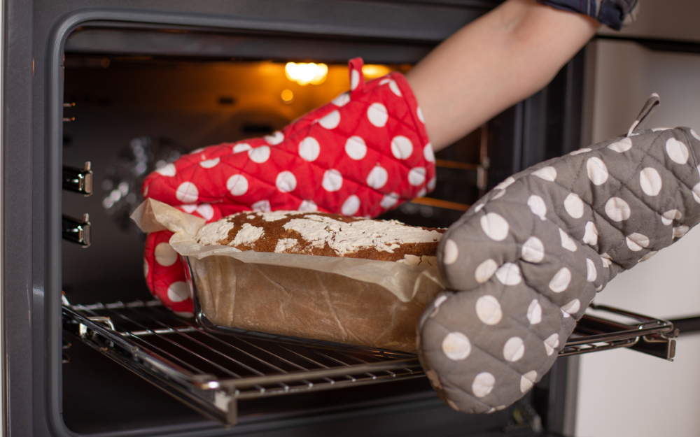 A cake being taken out of the oven