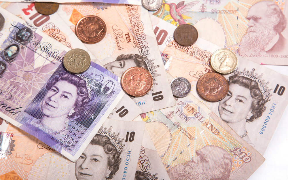 £20 notes and coins on a table