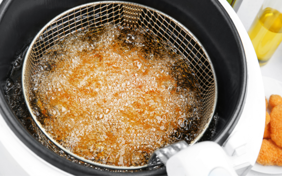 A close-up of the oil inside a deep fat fryer