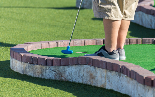 Person playing mini golf