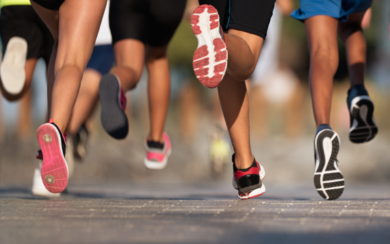 A close-up of the legs of running children