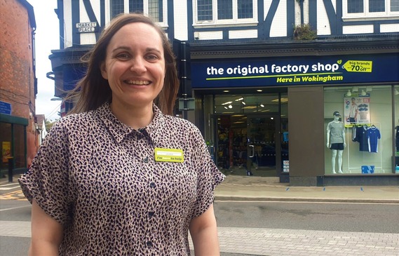 Shop assistant outside store in Wokingham