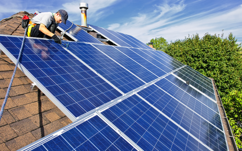 Solar panels being fit on the roof of a house