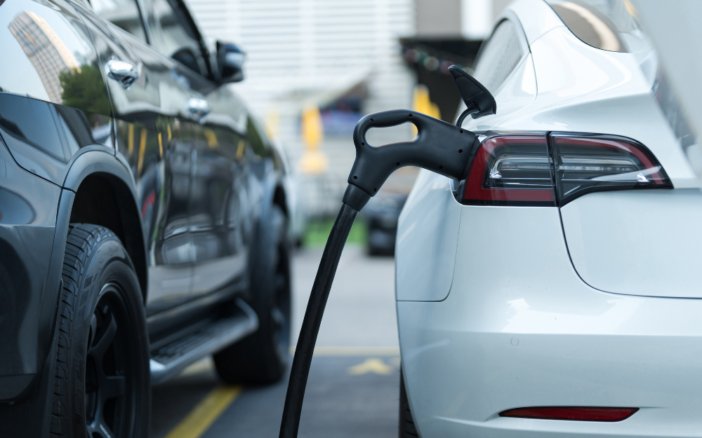 An electric car being charged in a car park