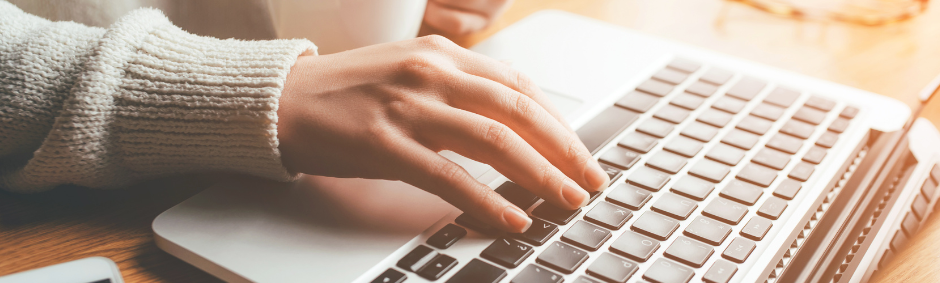 stock image of a single hand typing on a keyboard