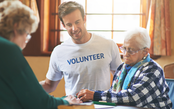 Volunteer helping elderly woman