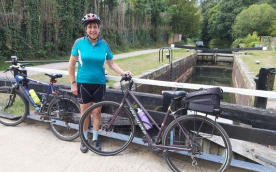 Jill standing by a canal with two bikes