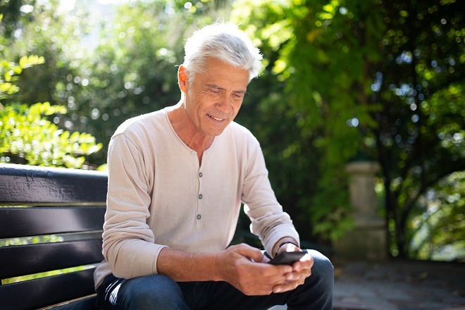 man on smart phone typing