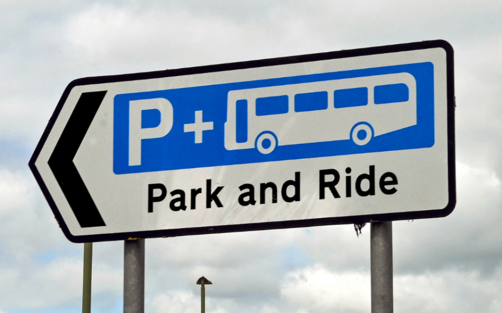 Stock image of a road sign pointing to a park and ride site