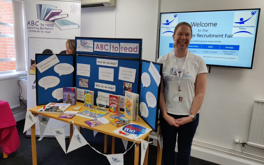 An ABC to read volunteer at their informaton stand at a volunteer information event