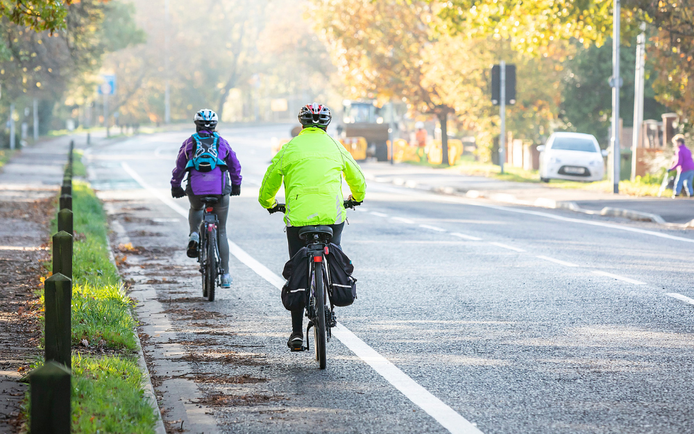 Two cyclists on their way to work in a cycle lane into Wokingham town centre