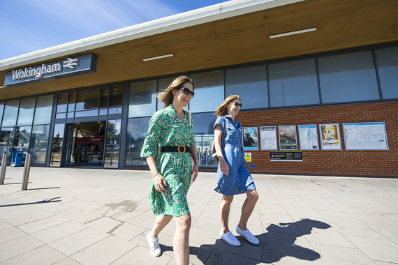 Two ladies walking past Wokingham train station