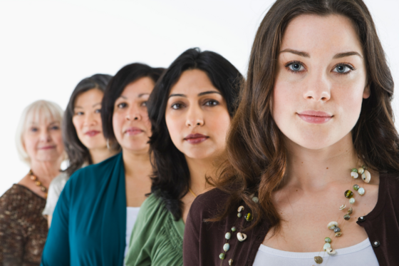 Photo of five women of different generations and ethnicities, standing up and looking strong and confident