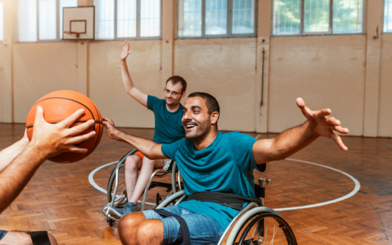 A few man on wheelchairs playing basketball