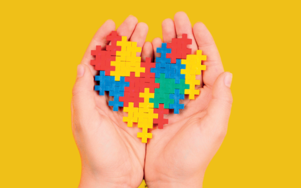 A heart shaped puzzle inside a pair of clasped open palms