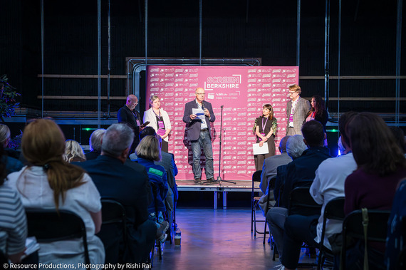 A small group of people presenting to a crowd from a stage, at the launch of Screen Berkshire at Shinfield Studios