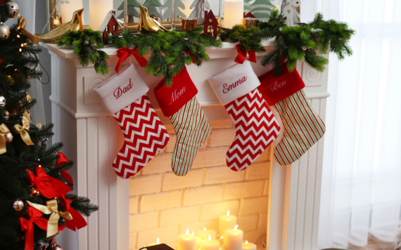 Four Christmas stocking hanging over a fireplace