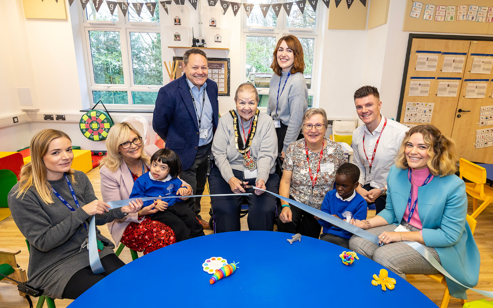 Children and staff cut the ribbon at the opening of the new Addington Early Years Centre in Farley Hill