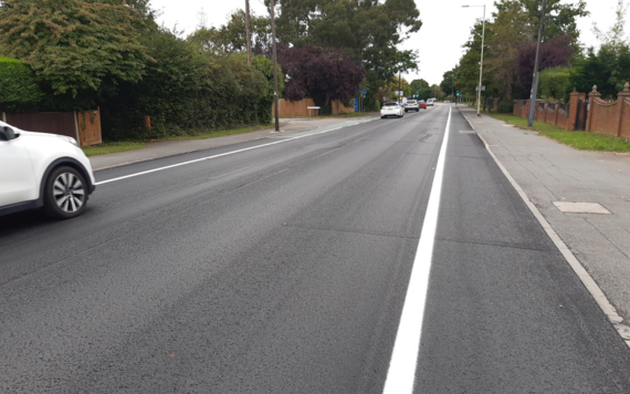 A road that has newly had asphalt preservation applied