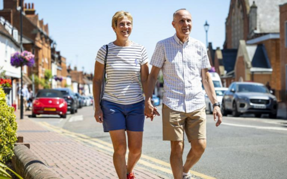 Two people smiling while walking down Rose Street in Wokingham