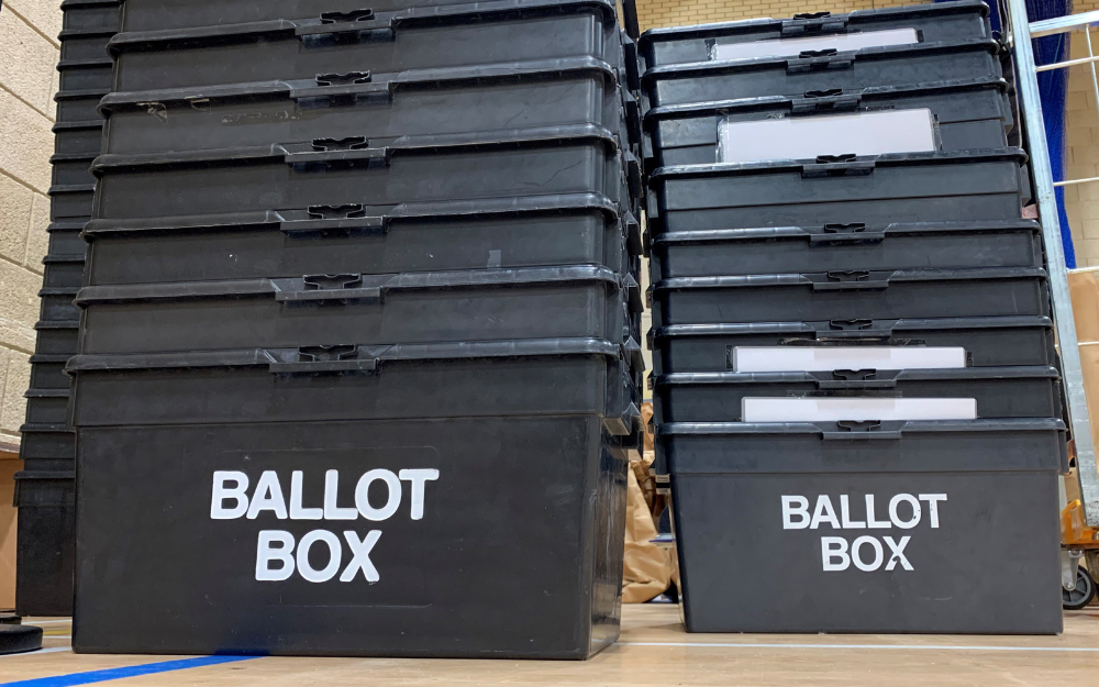 Stacks of ballot boxes on an election counting room floor