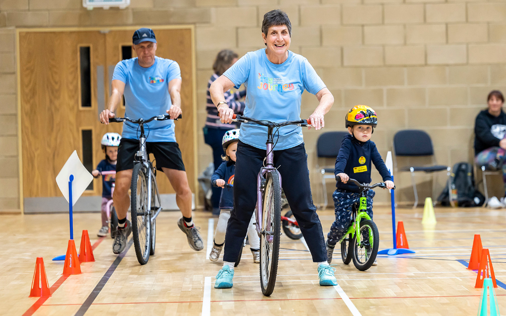 Award winning cycle trainer Jill Bissell smiling while teaching a cycling session to young children