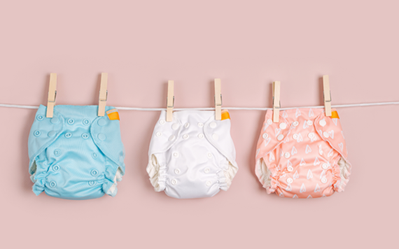 Three reusable nappies hanging on a cloth line