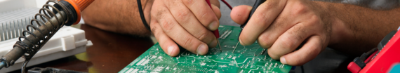 A man working on an electric circuitboard