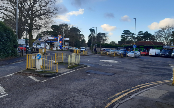 Current view of the junction taken across the two roundabouts showing the garage and shops