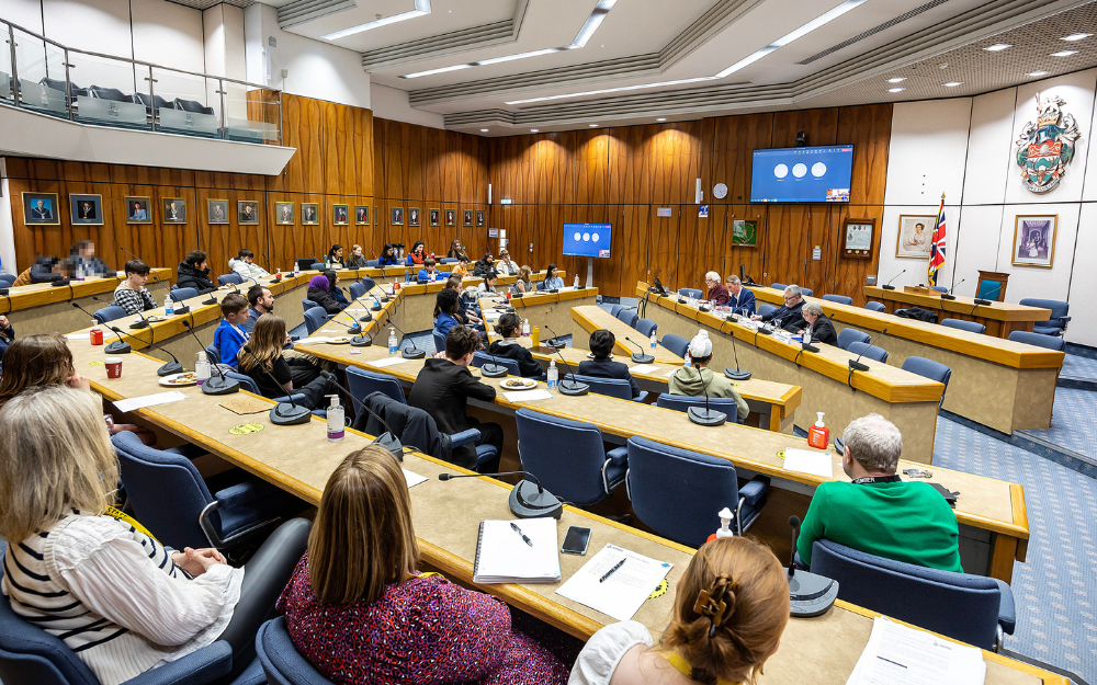 Dozens of young people in the council chamber for a youth politics event