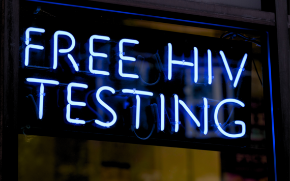 A neon sign which says free HIV testing