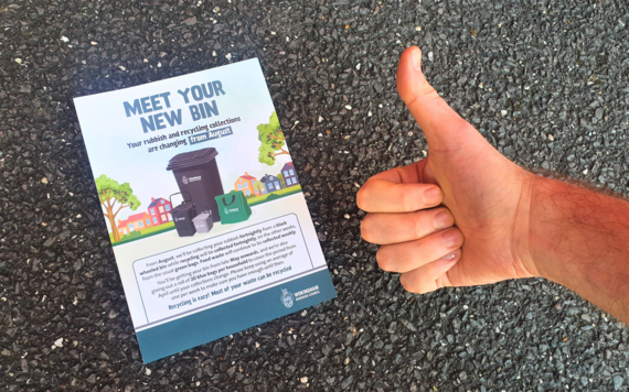 A photo showing the front cover of a leaflet, with a thumb up next to it 