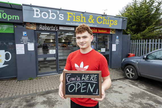 Picture of Bob's Fish and Chips with an employee standing out front with an Open for Business sign